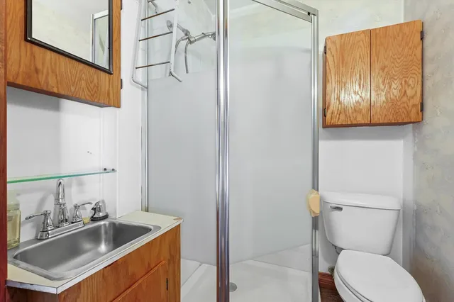 a bathroom with a toilet sink and mirror