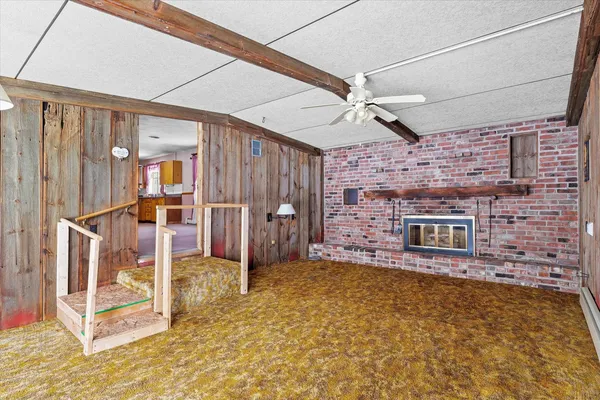 a view of an empty room with a fireplace