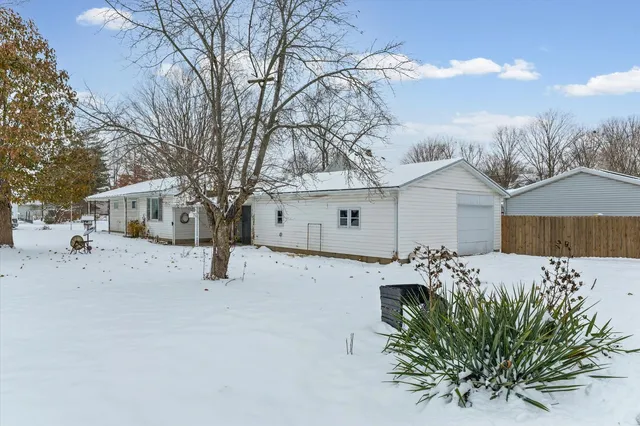 a view of a house with a snow in the yard