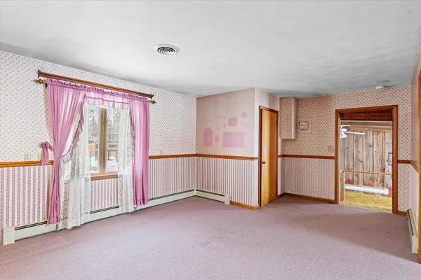 a view of an empty room with a fireplace