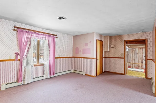 a view of an empty room with a fireplace