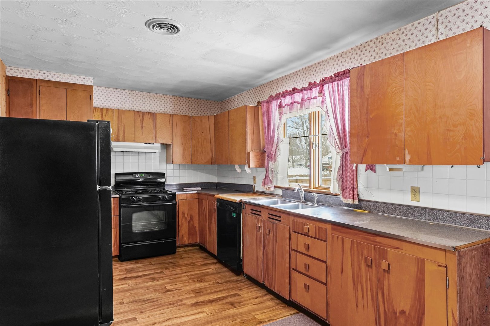 107 North Ellen Street Homer, IL 61849 - Photo 10 of 27 a kitchen with stainless steel appliances granite countertop a refrigerator a sink dishwasher a stove and white cabinets with wooden floor