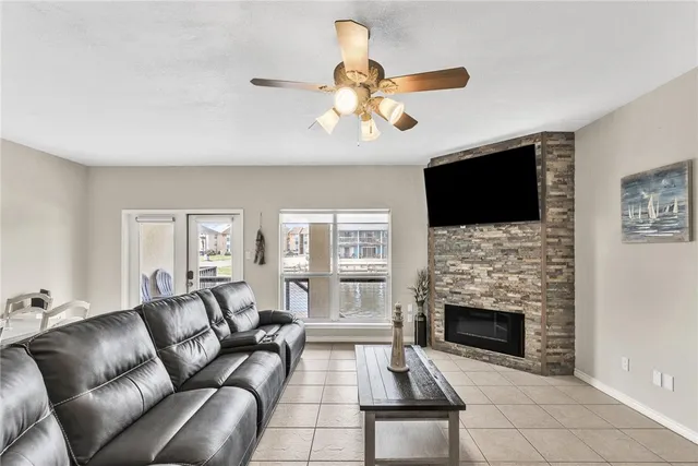 a living room with furniture a fireplace and a flat screen tv