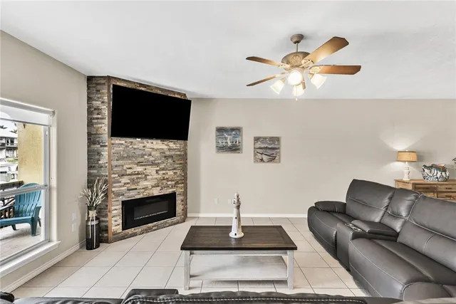 a living room with furniture a flat screen tv and a fireplace
