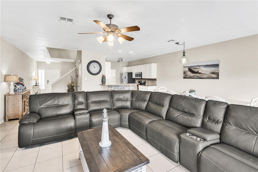 15417 Gun Cay Court, Unit B Corpus Christi, TX 78418 - Photo 13 of 35 a living room with couches and a large mirror with wooden floor
