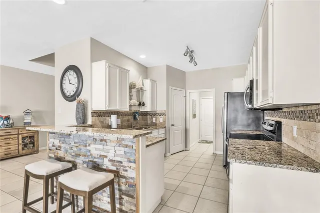 a large kitchen with a table and chairs