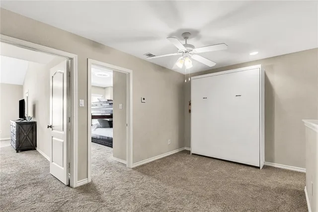 a view of a livingroom with a chandelier fan