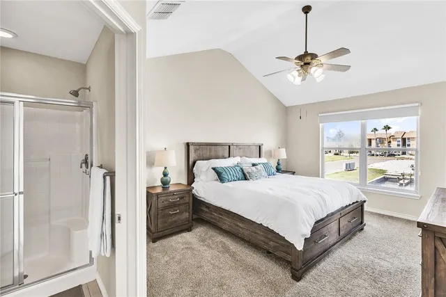a bedroom with a large bed and a chandelier