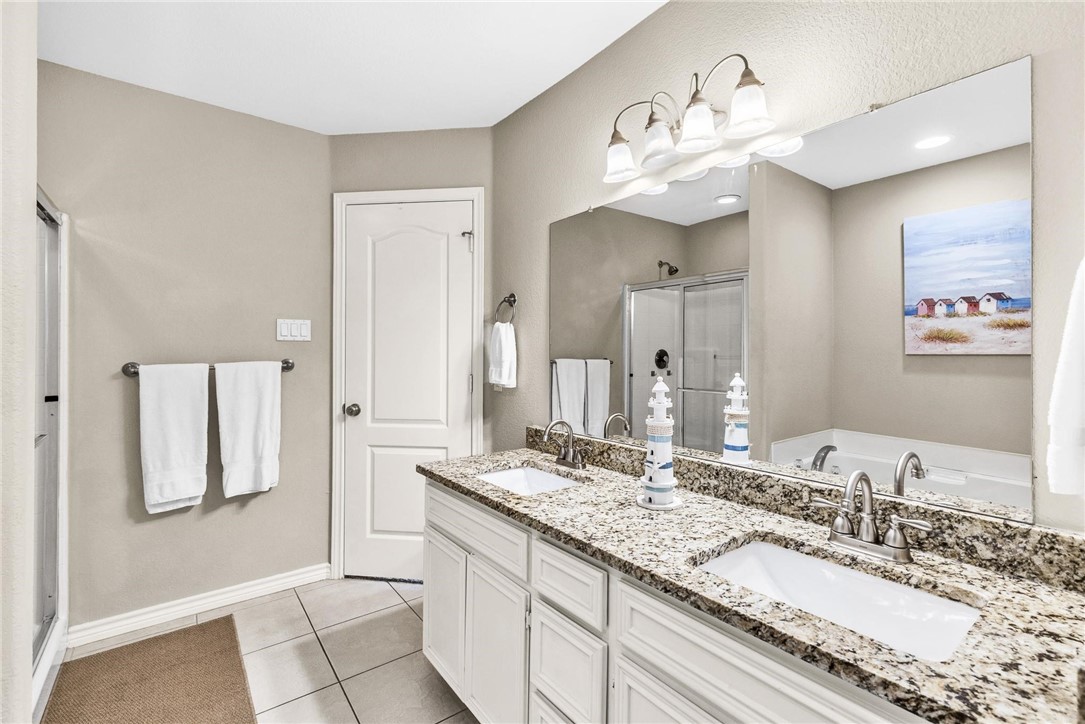 15417 Gun Cay Court, Unit B Corpus Christi, TX 78418 - Photo 27 of 35 a bathroom with a sink double vanity and a mirror