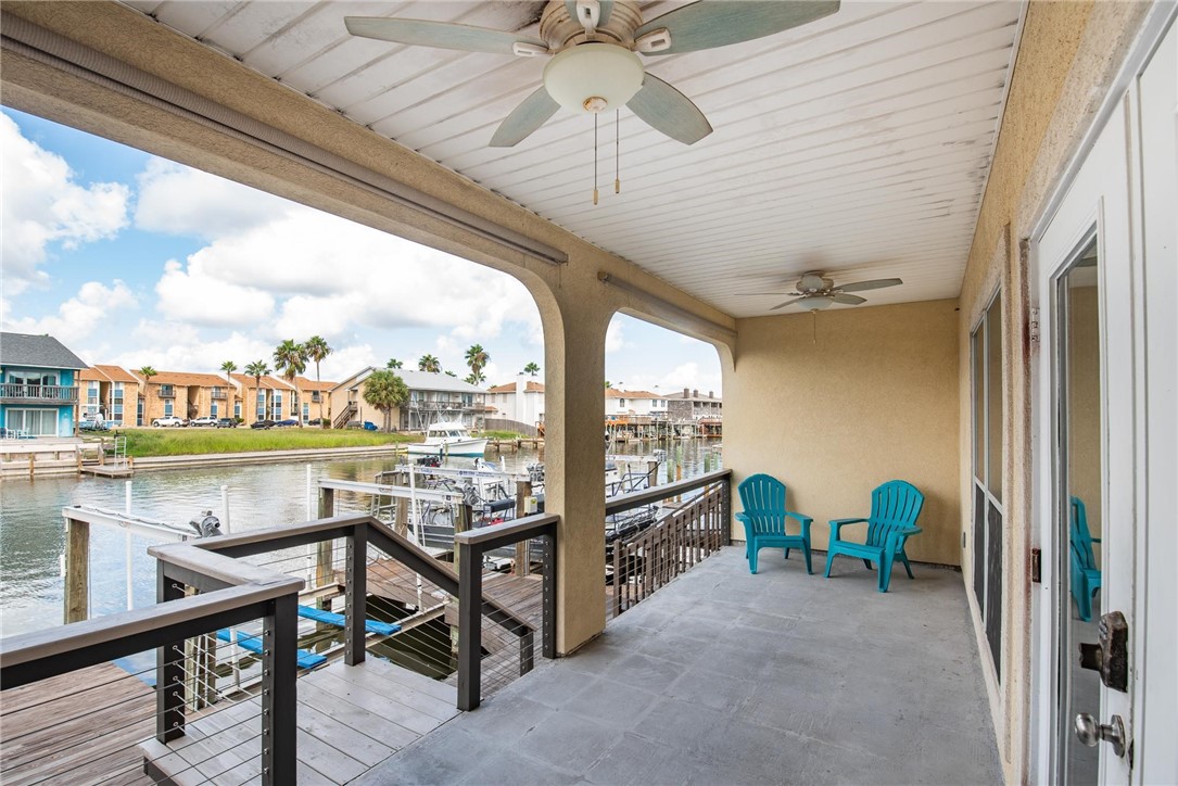 15417 Gun Cay Court, Unit B Corpus Christi, TX 78418 - Photo 30 of 35 a view of a balcony with furniture and a floor to ceiling window