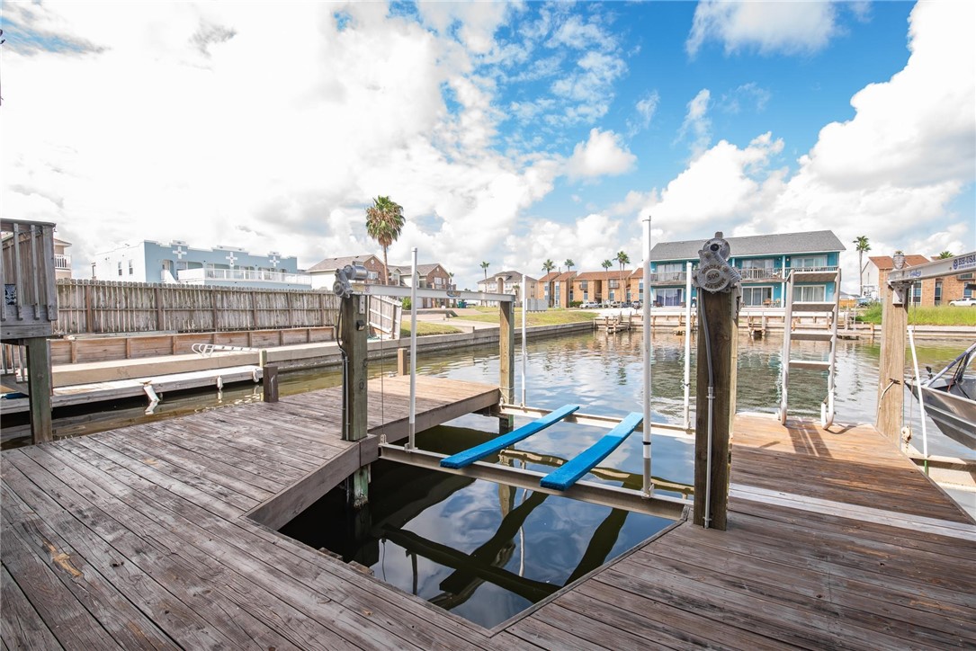 15417 Gun Cay Court, Unit B Corpus Christi, TX 78418 - Photo 32 of 35 a view of a terrace with wooden benches