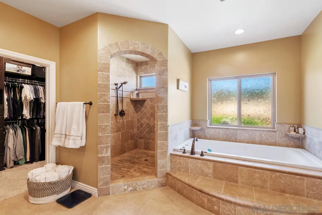1070 Heritage Ranch Road Ramona, CA 92065 - Photo 34 of 73 a bathroom with a tub a mirror and a shower