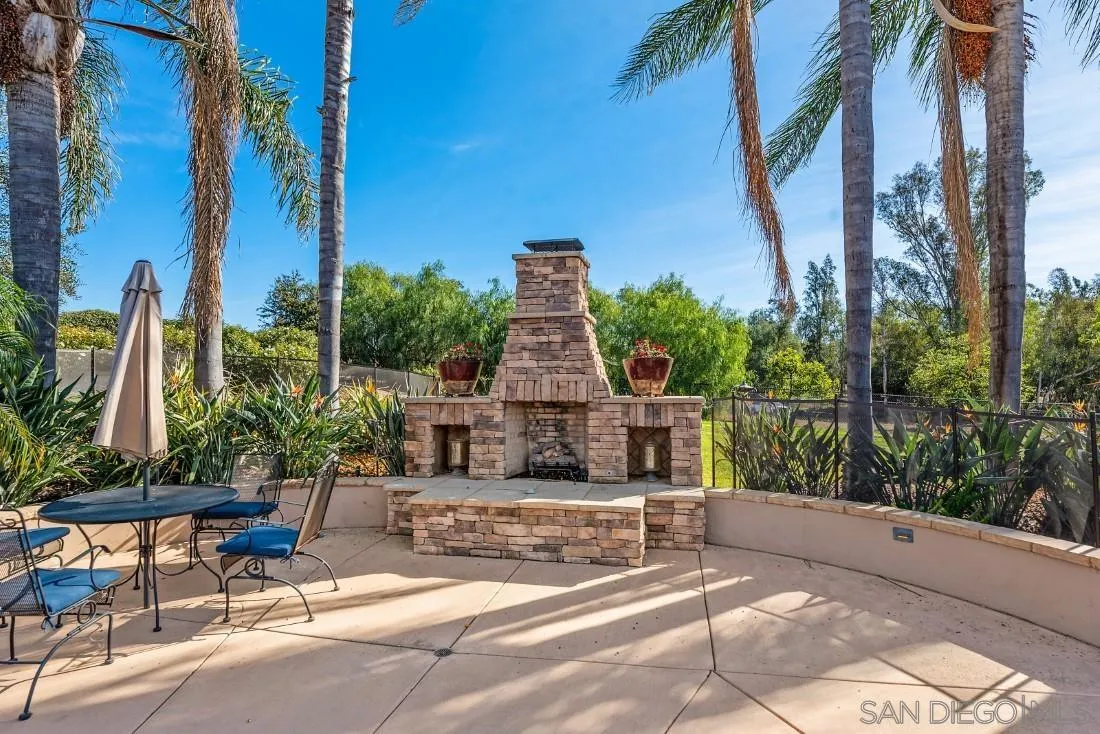 1070 Heritage Ranch Road Ramona, CA 92065 - Photo 54 of 73 a view of a patio with a table and chairs under an umbrella