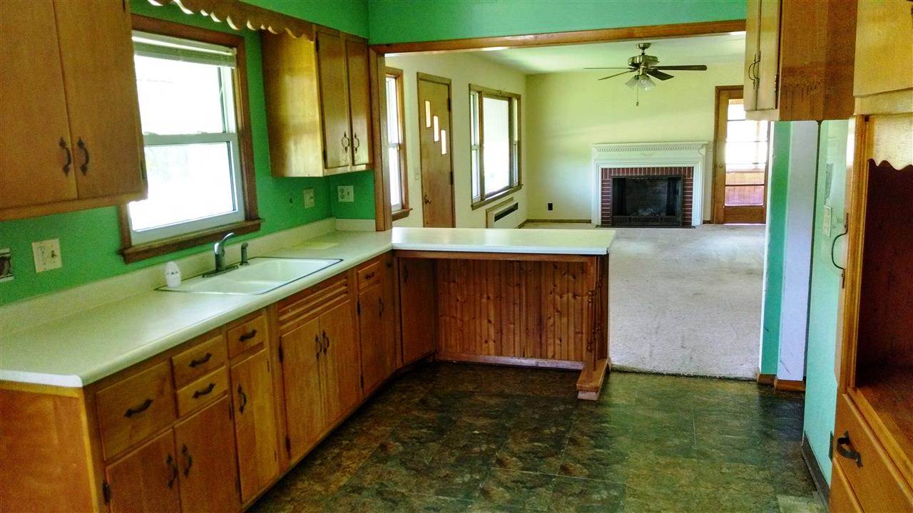 3219 Prairie Road Rockford, IL 61102 - Photo 5 of 12 a kitchen with sink cabinets and window