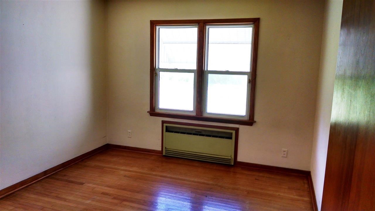 3219 Prairie Road Rockford, IL 61102 - Photo 9 of 12 an empty room with wooden floor and windows