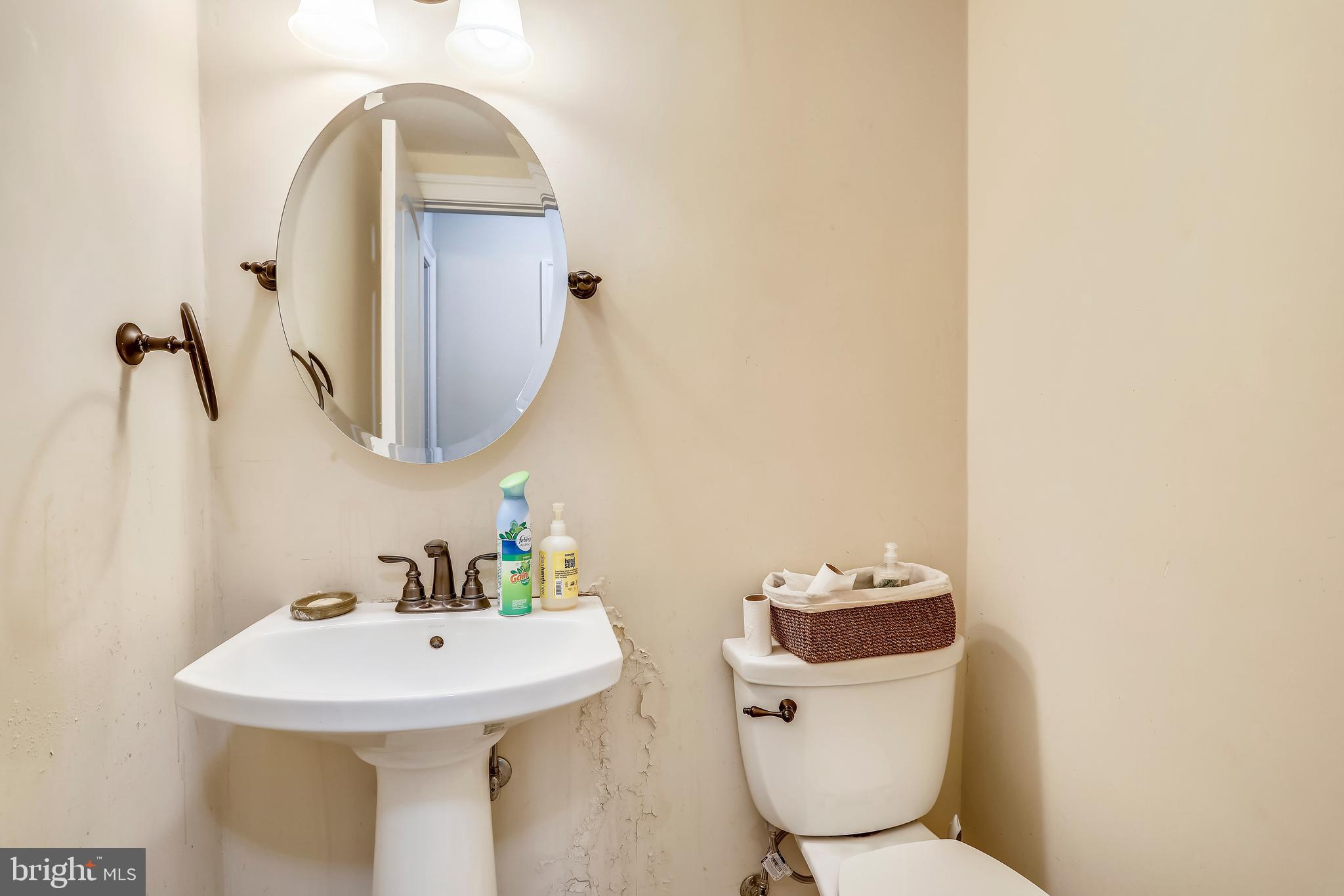 10145 Colebrook Avenue Potomac, MD 20854 - Photo 15 of 30 a bathroom with a toilet sink and mirror