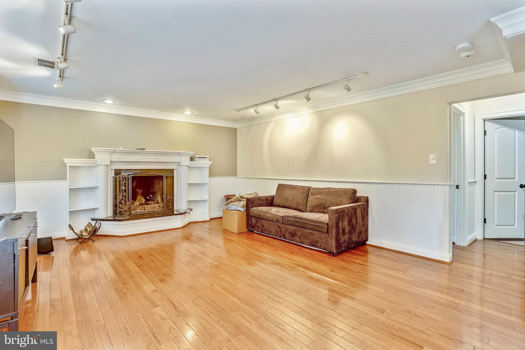 10145 Colebrook Avenue Potomac, MD 20854 - Photo 18 of 30 a living room with furniture and a fireplace