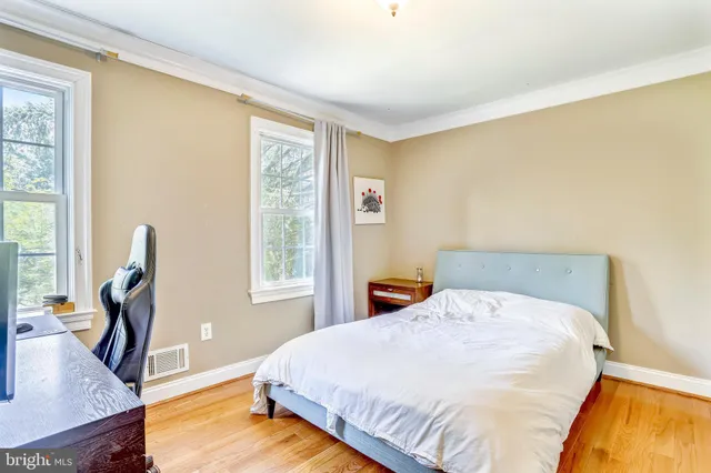 a bed sitting in a bedroom next to a window