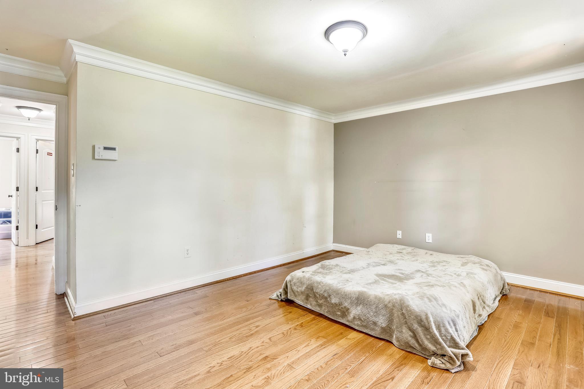 10145 Colebrook Avenue Potomac, MD 20854 - Photo 10 of 30 a bedroom with a bed and wooden floor