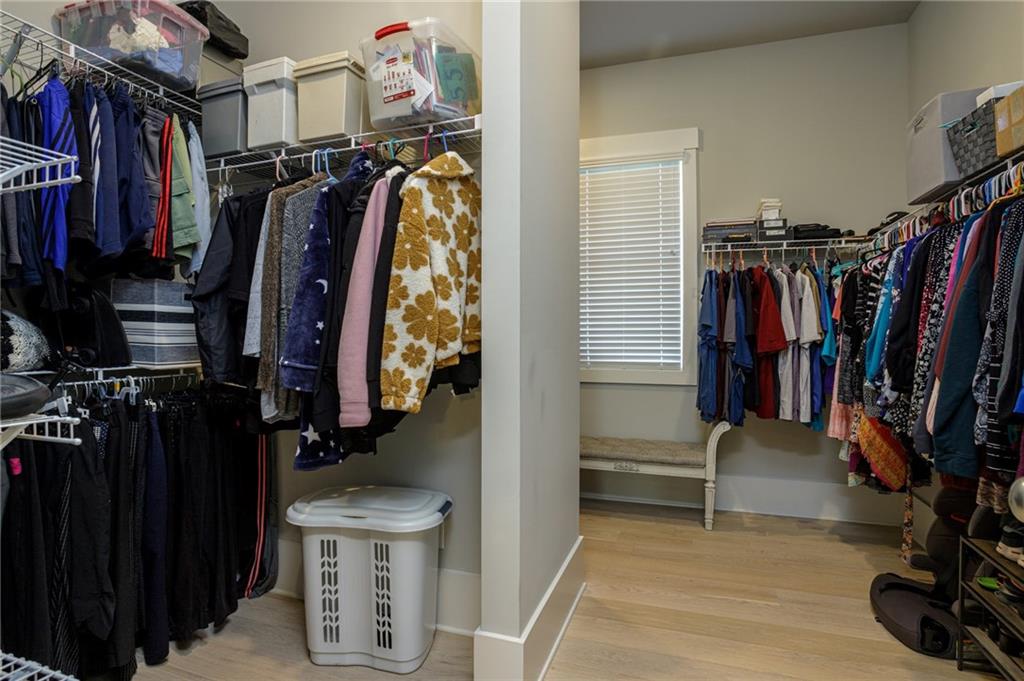 255 Old Town Road Dacula, GA 30019 - Photo 31 of 38 a view of walk in closet with clothes and shoes