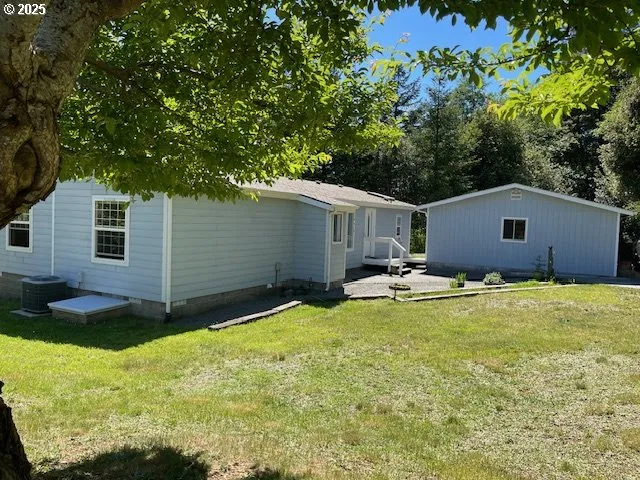 a view of a house with pool and a yard