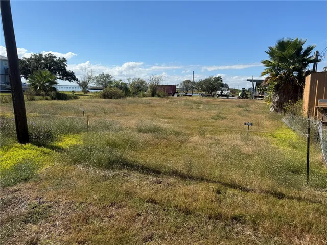 a view of a garden with a building in the background