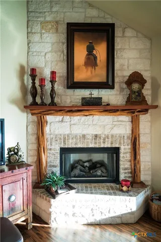 a living room with painting on the wall and a fireplace