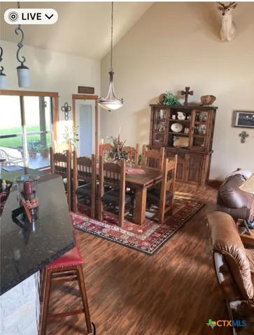 a living room with lots of chairs and a chandelier