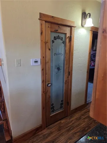 an empty room with wooden floor and closet