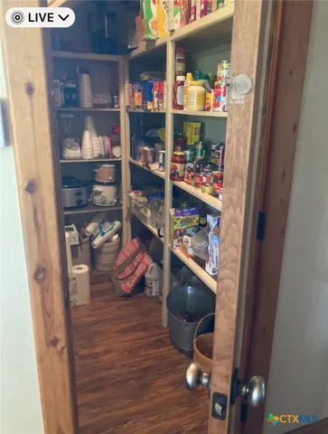 a room with wooden floor and shoes