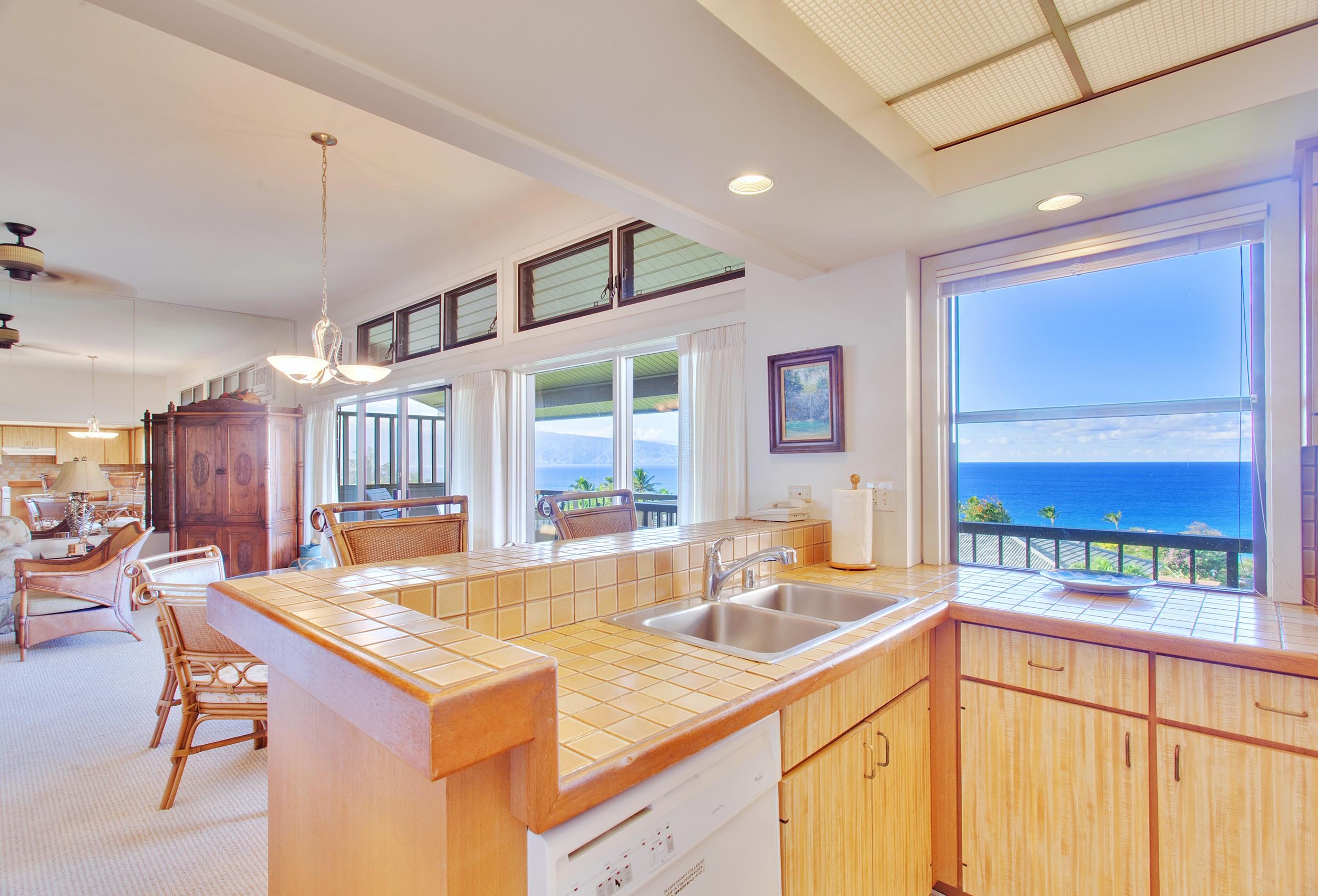 100 Ridge Road, Unit 321 Lahaina, HI 96761 - Photo 7 of 30 a kitchen with a sink and a large window
