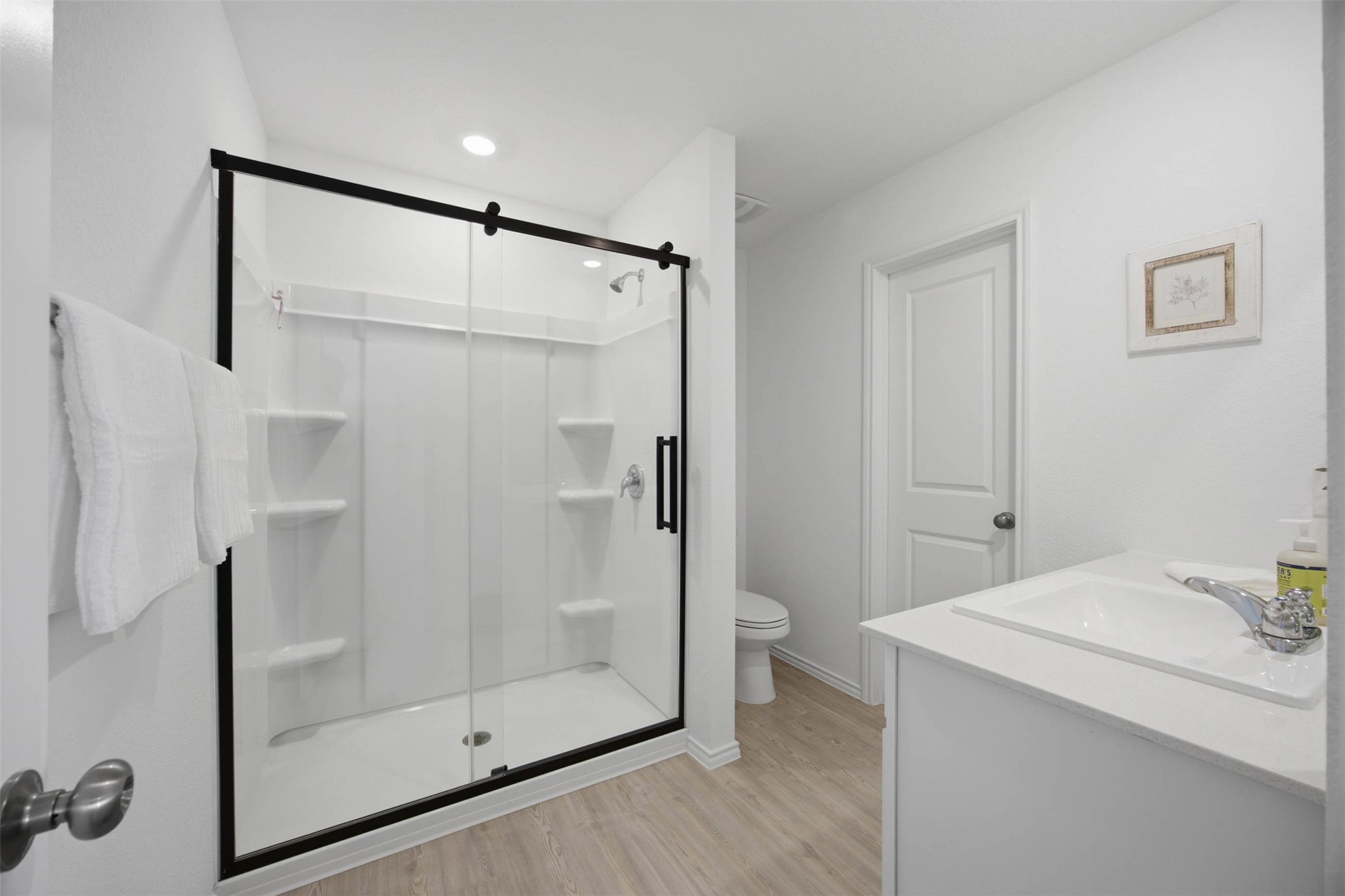 171 Cattle Queen Road Jarrell, TX 76537 - Photo 22 of 38 Smooth vinyl flooring and a modern glass-enclosed shower define this clean bathroom space.