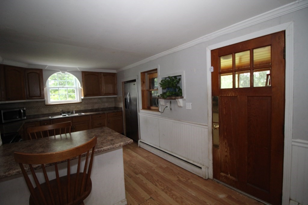 91 Davis Road Westminster, MA 01473 - Photo 18 of 37 a kitchen with a table chairs refrigerator and sink