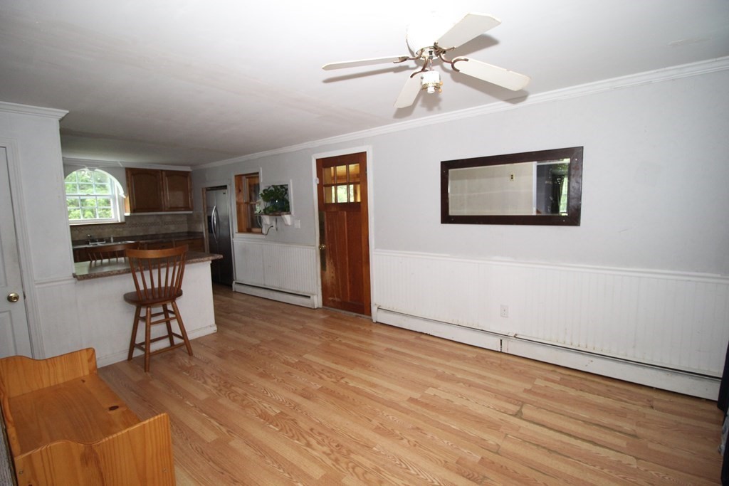 91 Davis Road Westminster, MA 01473 - Photo 20 of 37 a view of a workspace with furniture and a chandelier fan