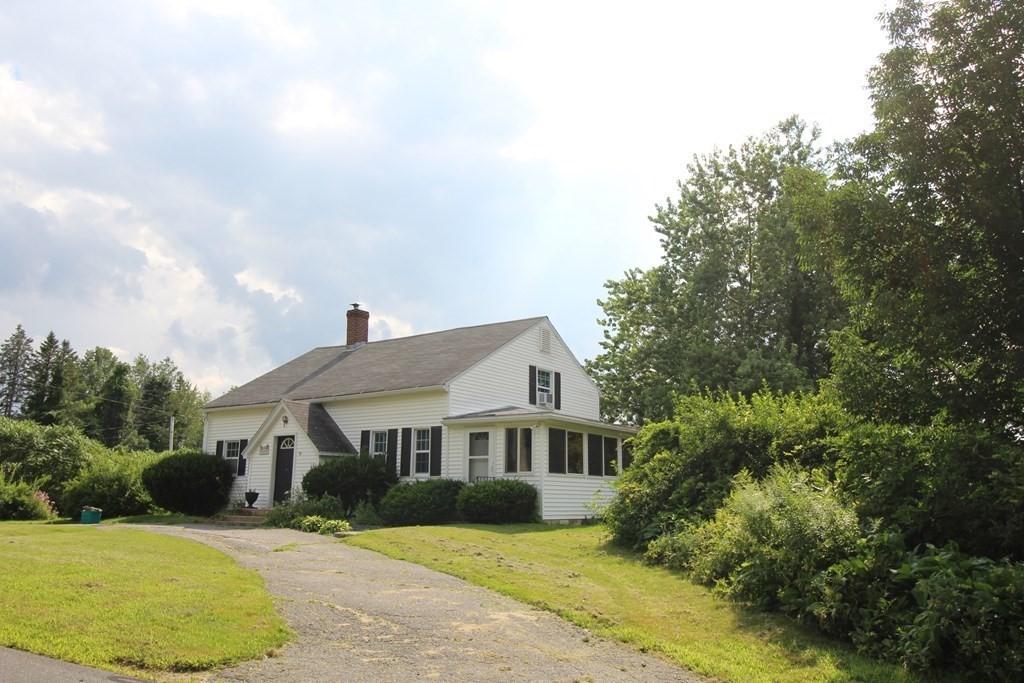 91 Davis Road Westminster, MA 01473 - Photo 2 of 37 a front view of a house with a garden and yard