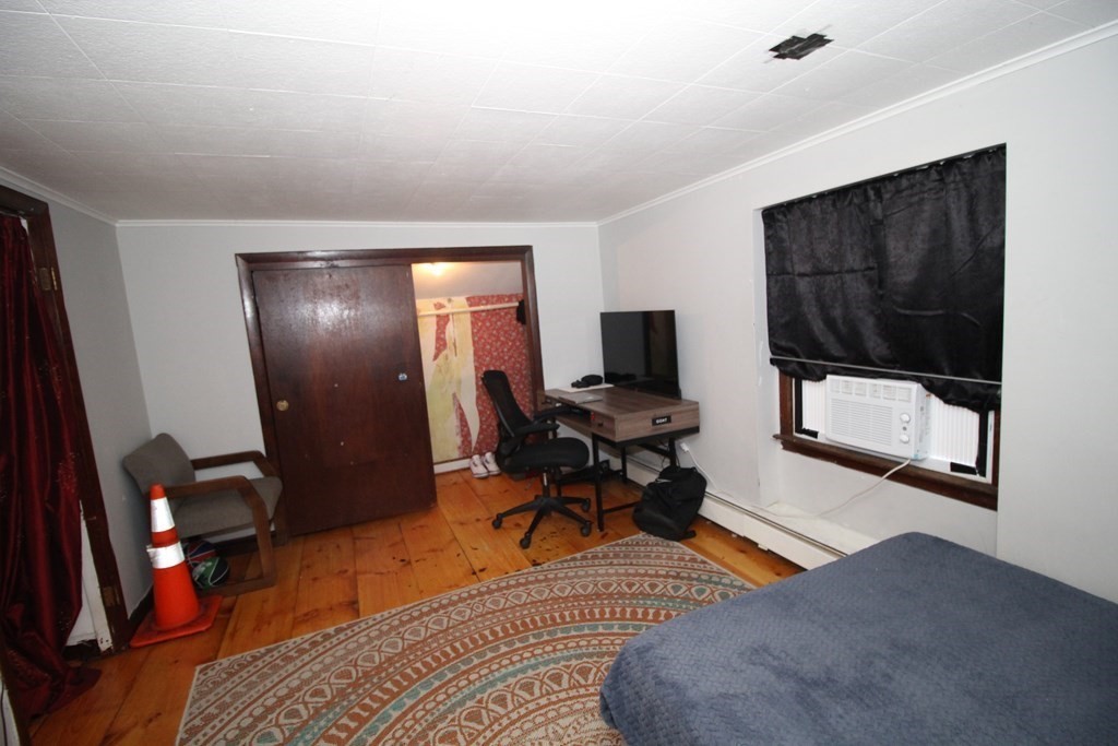 91 Davis Road Westminster, MA 01473 - Photo 25 of 37 a living room with furniture a flat screen tv and a mirror