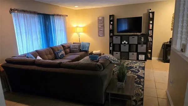 a living room with furniture and a flat screen tv