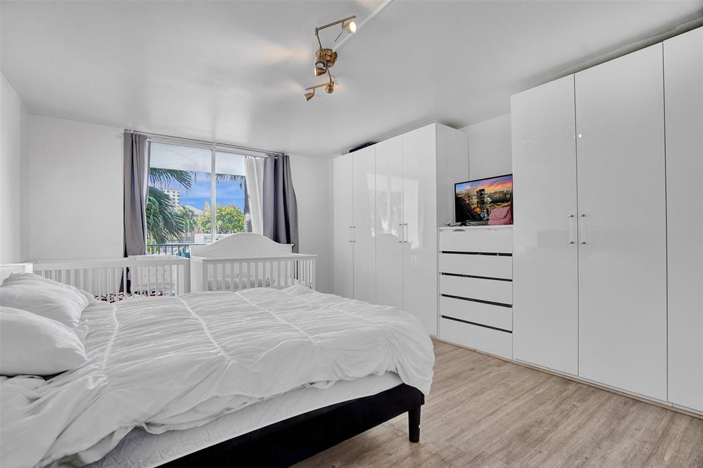 2801 Northeast 183rd Street, Unit 101W Aventura, FL 33160 - Photo 11 of 39 a bedroom with a bed and a window