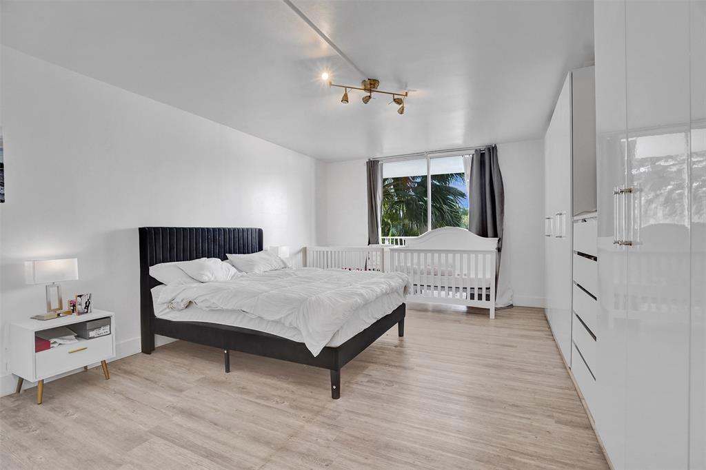 2801 Northeast 183rd Street, Unit 101W Aventura, FL 33160 - Photo 12 of 39 a bedroom with a bed and a window