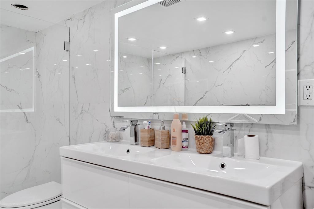 2801 Northeast 183rd Street, Unit 101W Aventura, FL 33160 - Photo 14 of 39 a bathroom with a sink a toilet and shower