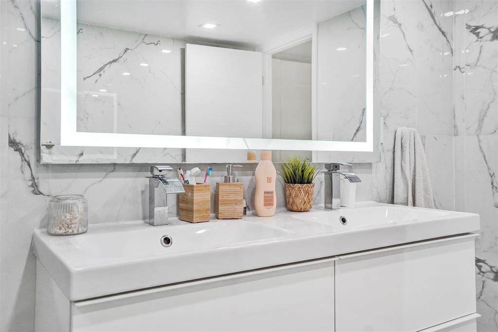 2801 Northeast 183rd Street, Unit 101W Aventura, FL 33160 - Photo 16 of 39 a bathroom with a sink and a mirror