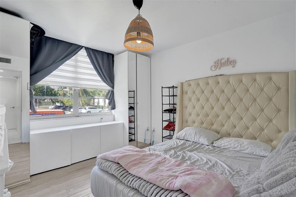 2801 Northeast 183rd Street, Unit 101W Aventura, FL 33160 - Photo 17 of 39 a bedroom with a bed and a large window