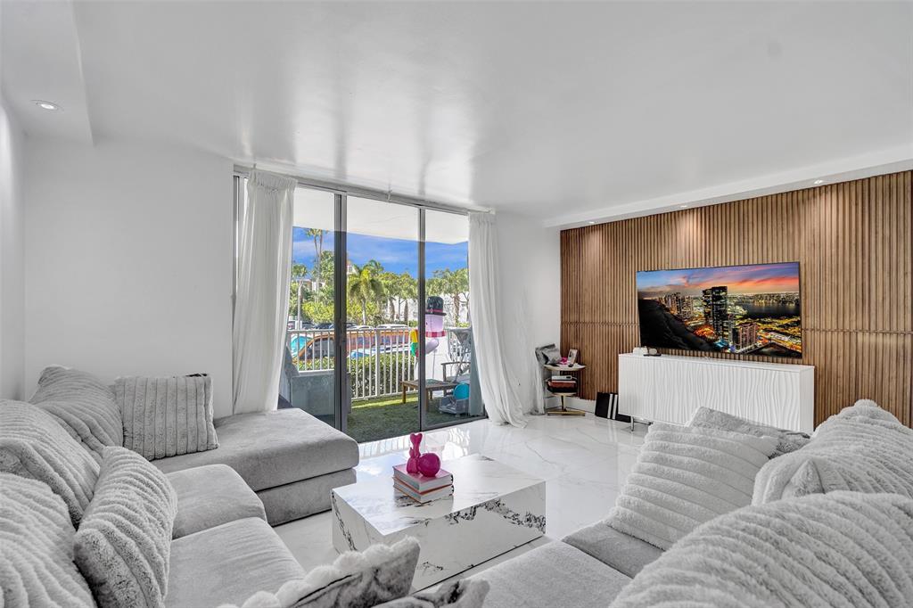 2801 Northeast 183rd Street, Unit 101W Aventura, FL 33160 - Photo 19 of 39 a living room with furniture and a flat screen tv