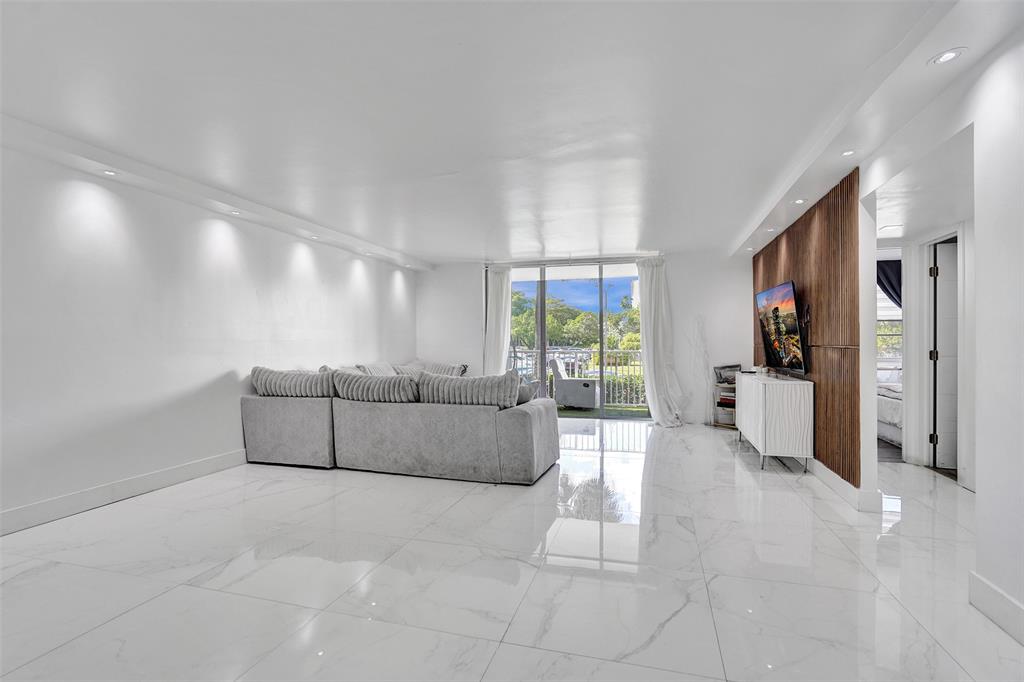 2801 Northeast 183rd Street, Unit 101W Aventura, FL 33160 - Photo 21 of 39 a living room with furniture and a large window
