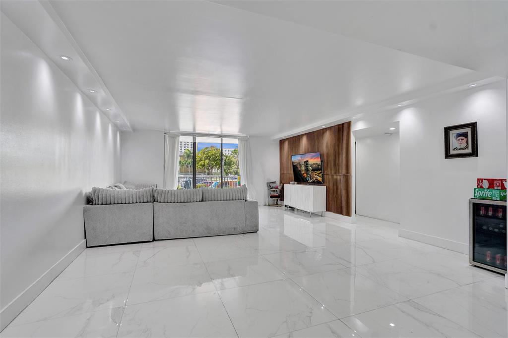 2801 Northeast 183rd Street, Unit 101W Aventura, FL 33160 - Photo 22 of 39 a living room with furniture and a window