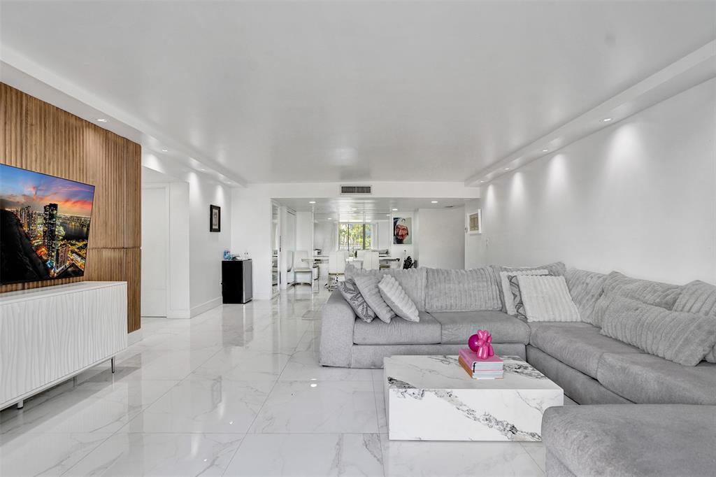 2801 Northeast 183rd Street, Unit 101W Aventura, FL 33160 - Photo 23 of 39 a living room with furniture and white walls