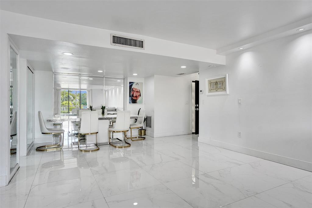 2801 Northeast 183rd Street, Unit 101W Aventura, FL 33160 - Photo 26 of 39 a living room with lots of white furniture and window