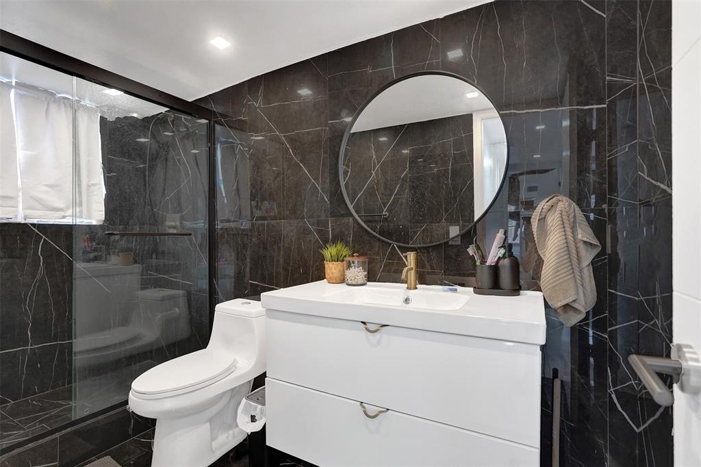 2801 Northeast 183rd Street, Unit 101W Aventura, FL 33160 - Photo 30 of 39 a bathroom with a washer and a mirror