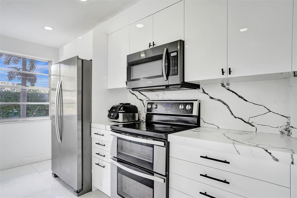 2801 Northeast 183rd Street, Unit 101W Aventura, FL 33160 - Photo 3 of 39 a kitchen with stainless steel appliances and cabinets
