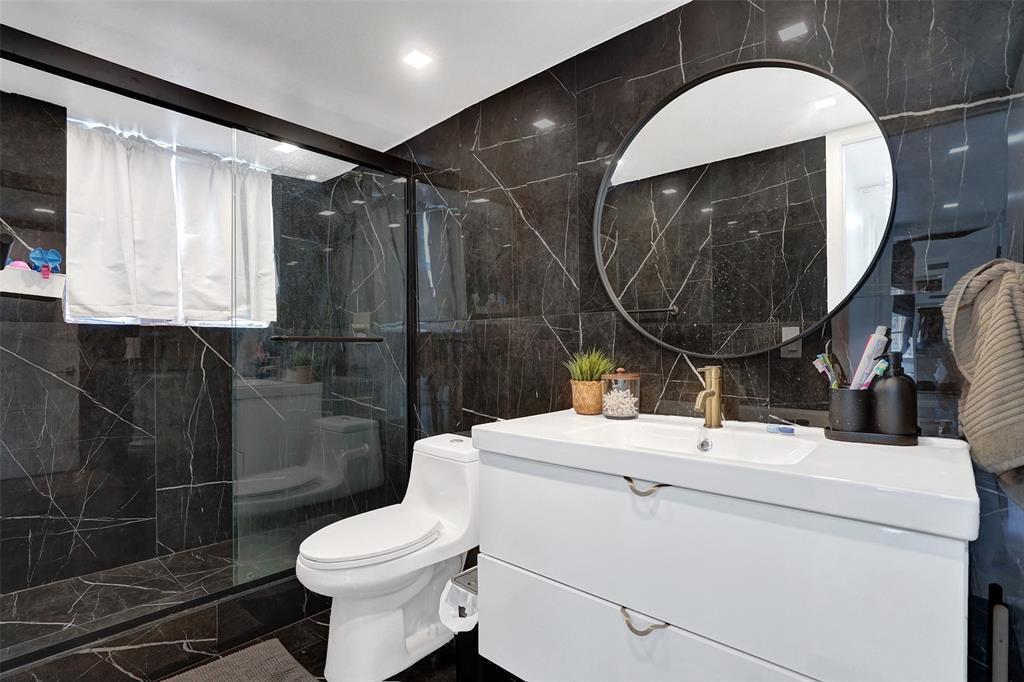 2801 Northeast 183rd Street, Unit 101W Aventura, FL 33160 - Photo 31 of 39 a bathroom with a sink toilet and a mirror